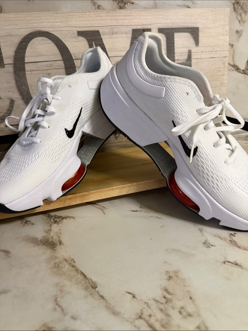 Nike White Athletic Sneakers with Black Swoosh and Red Accent